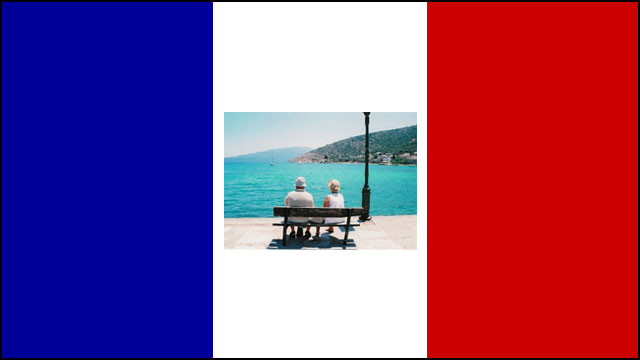 retired couple on bench at beach